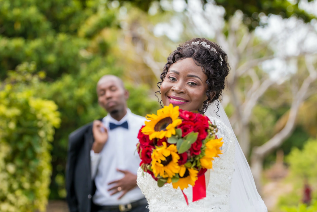 black bride extends her bouquet, newly married. 